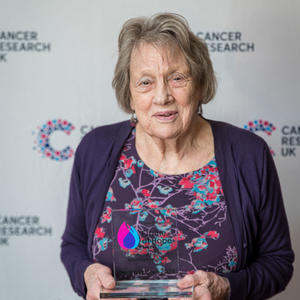 Margaret holding her Flame of Hope trophy