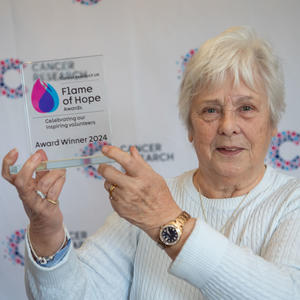 Maureen holding her Flame of Hope trophy