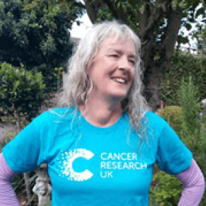 Sarah Hart smiling in a blue CRUK t-shirt