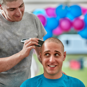 Man having his hair shaved off