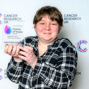 Siobhan holding her Flame of Hope award