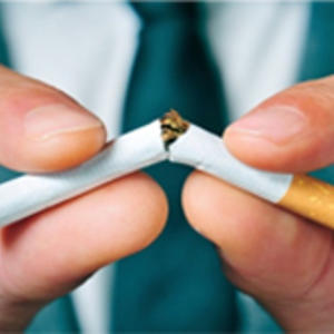 A close up of a cigarette being broken in half to show its contents 