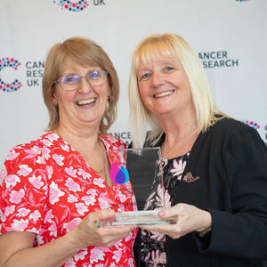 Val holding her Flame of Hope trophy and guest