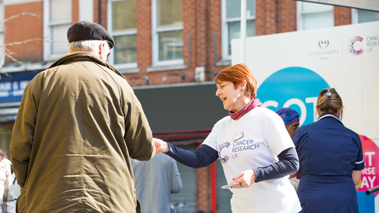 Picture of woman handing flyer to man