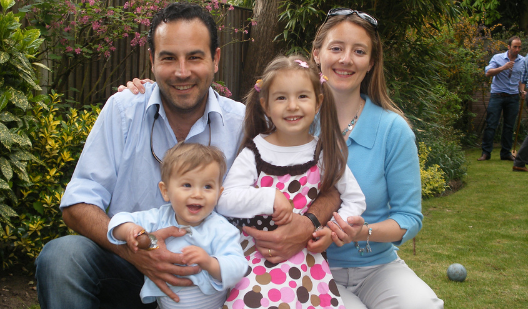 Alim smiling with his wife and 2 children Alim smiling with his wife and 2 children