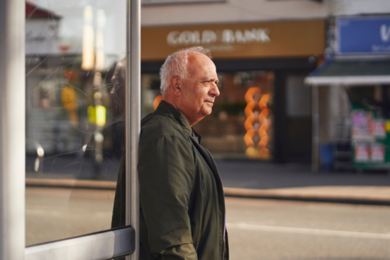 Man waiting at a bust stop