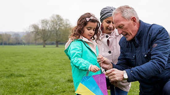 Photo of family playing with a kite