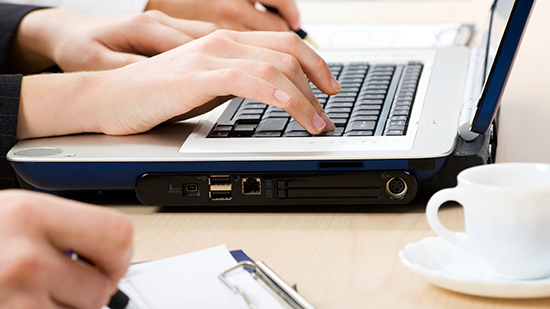 Image of someone at a laptop