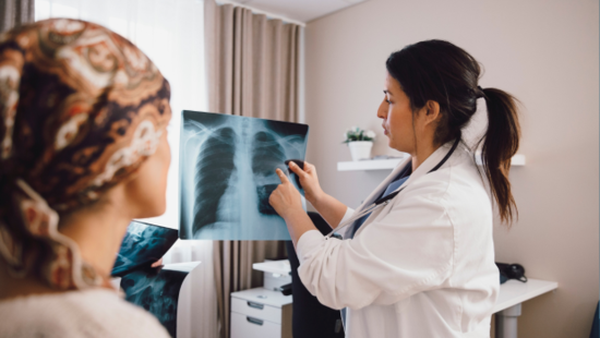Dr showing patient a x-ray of lungs 