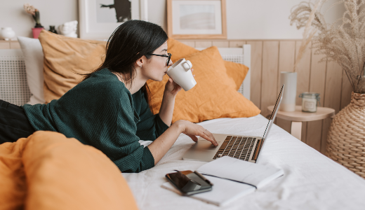 lady on bed on laptop