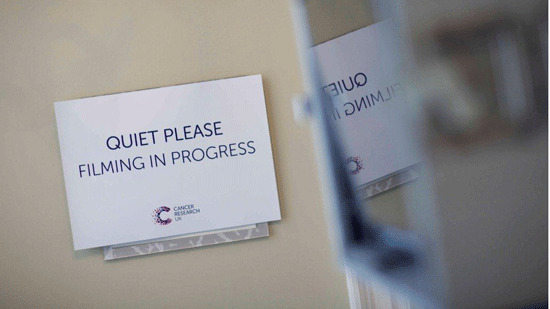 Sign that says 'quiet please, filming in progress'