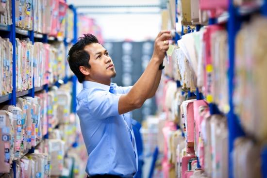 Image of man looking at lots of folders