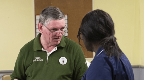 Photo of a Tesco worker conversating with a nurse