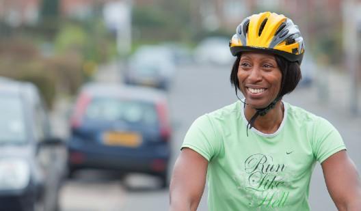Yvonne, a breast cancer survivor, riding a bicycle Yvonne riding a bicycle