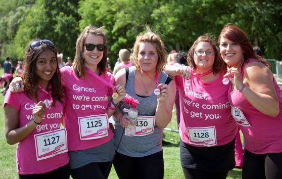 Women standing showing their Race for Life medals