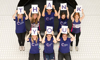 People holding up letters spelling 'Thank you'