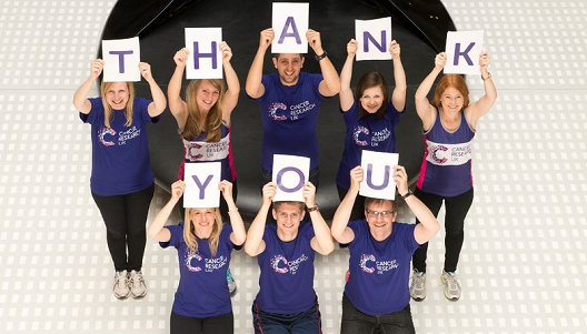 People holding up letters spelling 'Thank you'