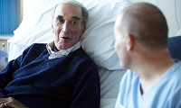 Male patient speaking with a male nurse
