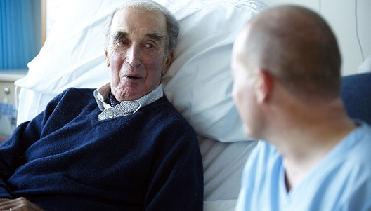 Male patient talking to a male nurse