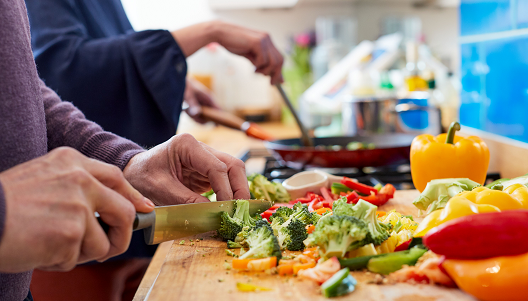 Hands of person chopping vegetables