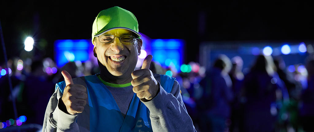 Volunteer with their thumbs up