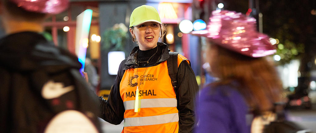 Volunteer directing supporters at a Shine Night Walk event
