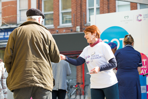 Picture of woman handing flyer to man