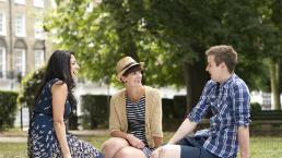 Happy friends chat in the sun