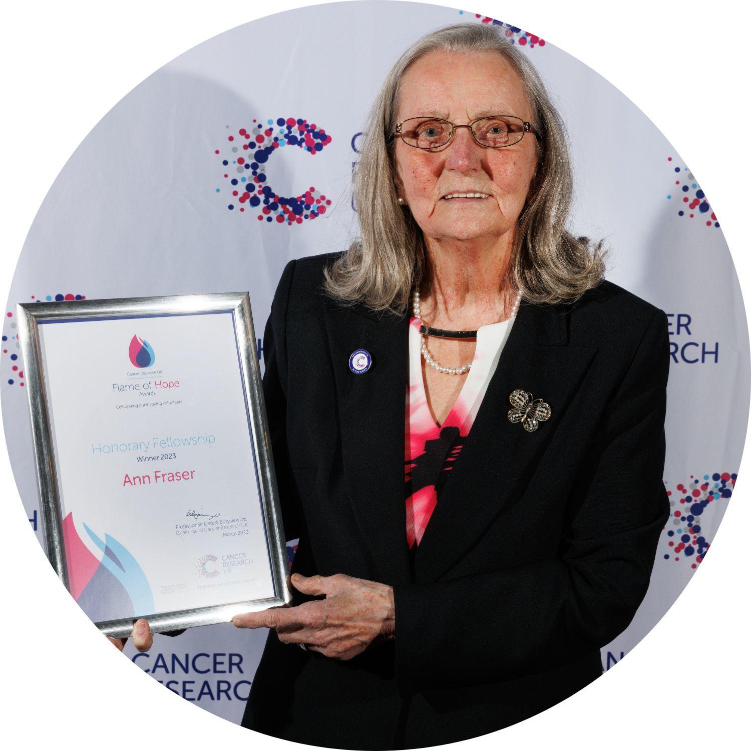 Ann holding her Flame of Hope certificate
