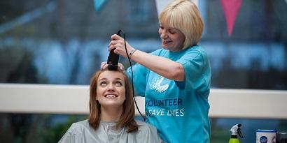 A fundraiser getting her head shaved
