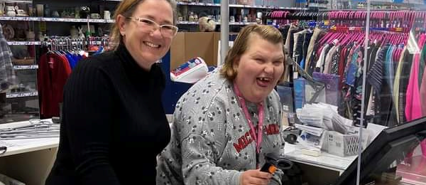 Bev and Jessica behind the till in a Cancer Research UK Shop