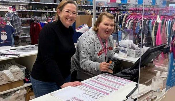 Bev & Jessica smiling behind the till