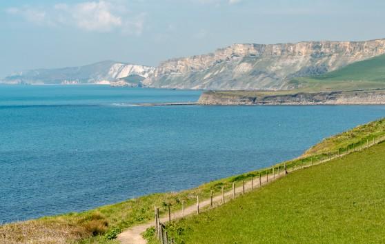 Big Hike Jurassic Coast route along the top of cliffs with a view of the sea and further cliffs in the background.