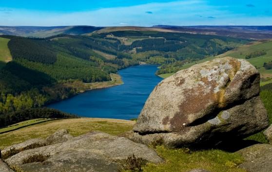 Big Hike route in the Peak District showing scenic view of a lake at the bottom of a tree covered valley