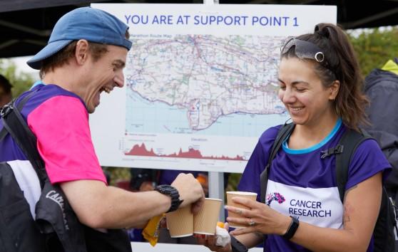 Two Big Hike participants at support points sharing cups of coffee