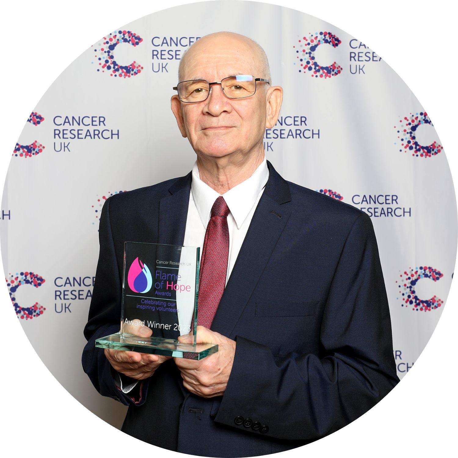 Brian holding a Flame of Hope trophy