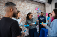 A group of volunteers chatting and holding refreshments