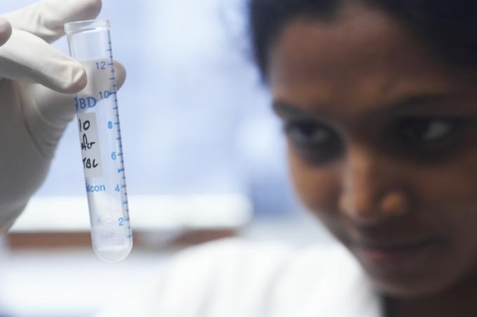 Scientist looking at liquid in a test tube