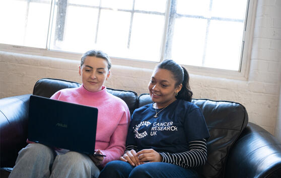 two women using laptop