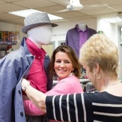 Volunteers dressing a manequin