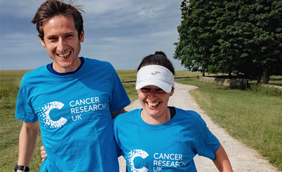 Couple walking in CRUK t-shirts
