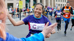 CRUK runner giving a high five