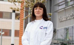 Pledge to leave a gift in your Will A female researcher with dark hair standing outside in a CRUK lab coat