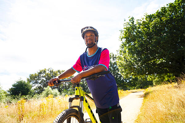 Man smiling wearing a bicycle helmet