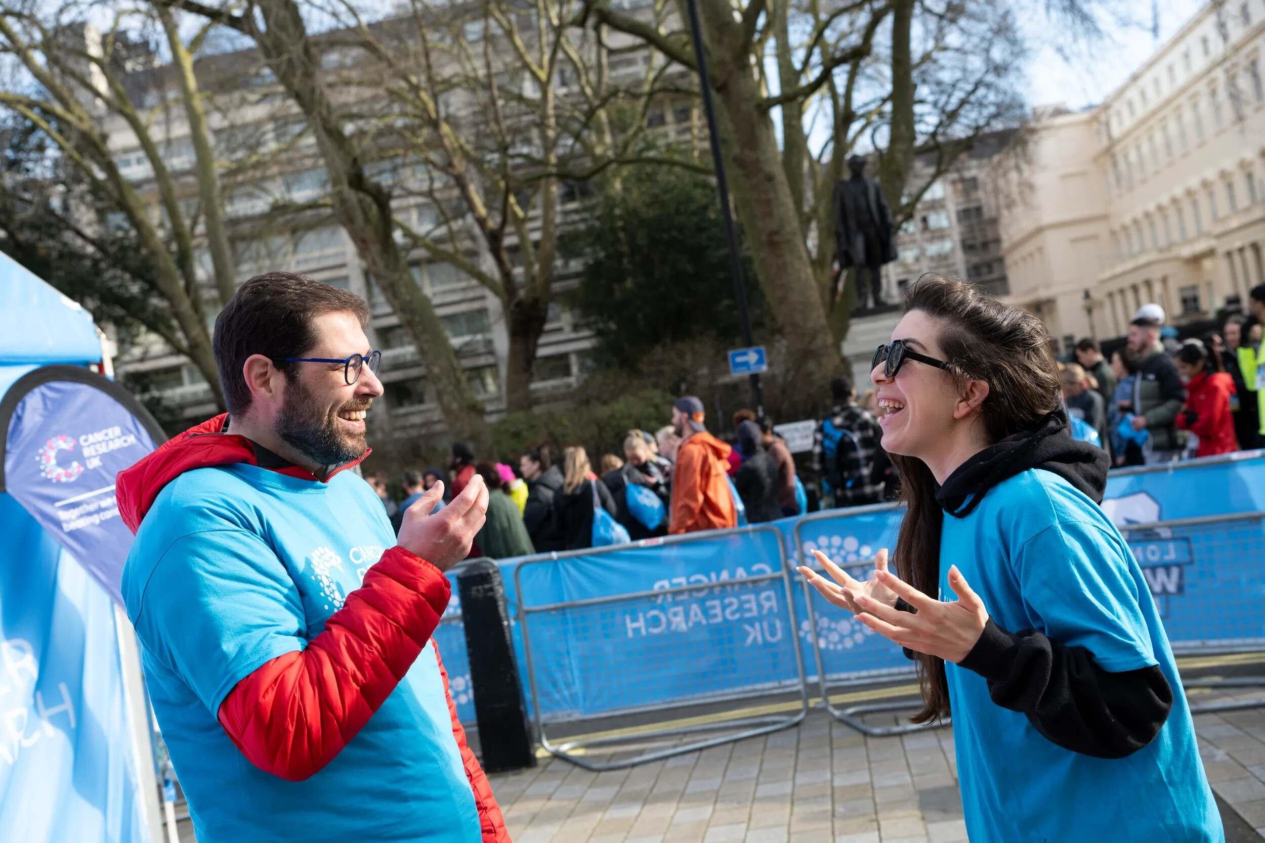 Two event volunteers smiling