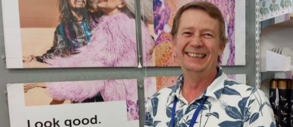 Dave - male smiling in Cancer Research Store wearing patterned shirt