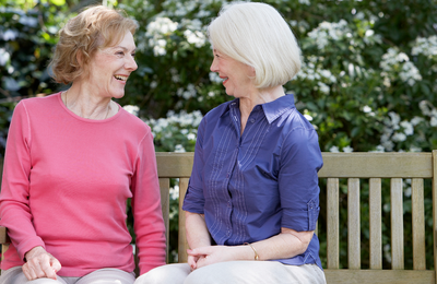 Conversation between old friends sitting on a bench