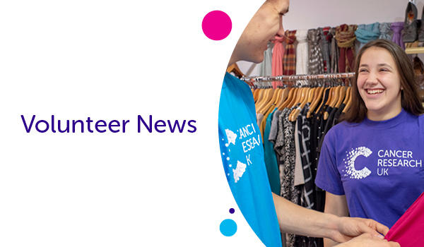 Girl in a purple t shirt laughing as she sorts clothes in a shop