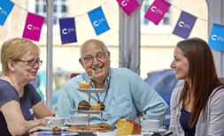 Cancer Research UK supporters sat at a table together 