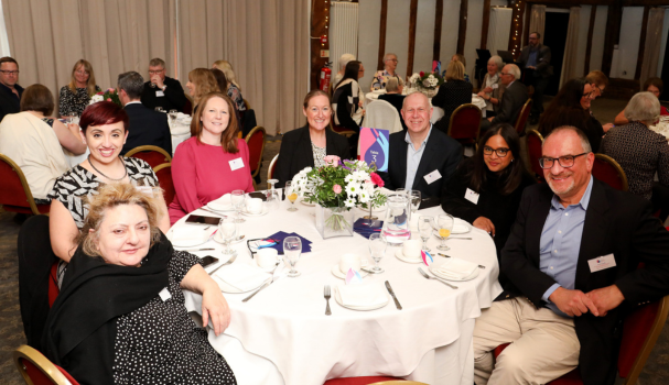 Group of people smiling round a table